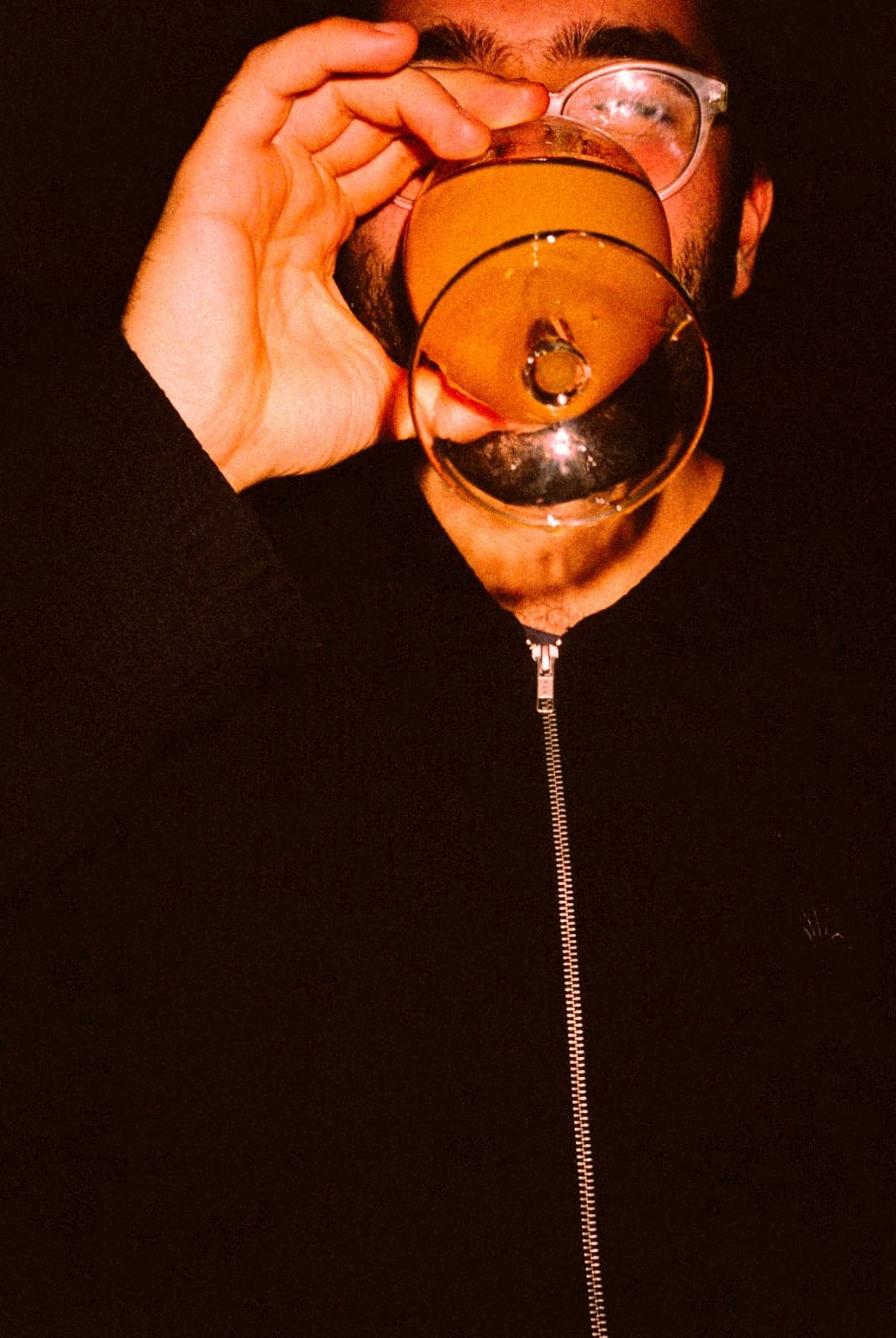 Honey Lou — man looking through cocktail glass