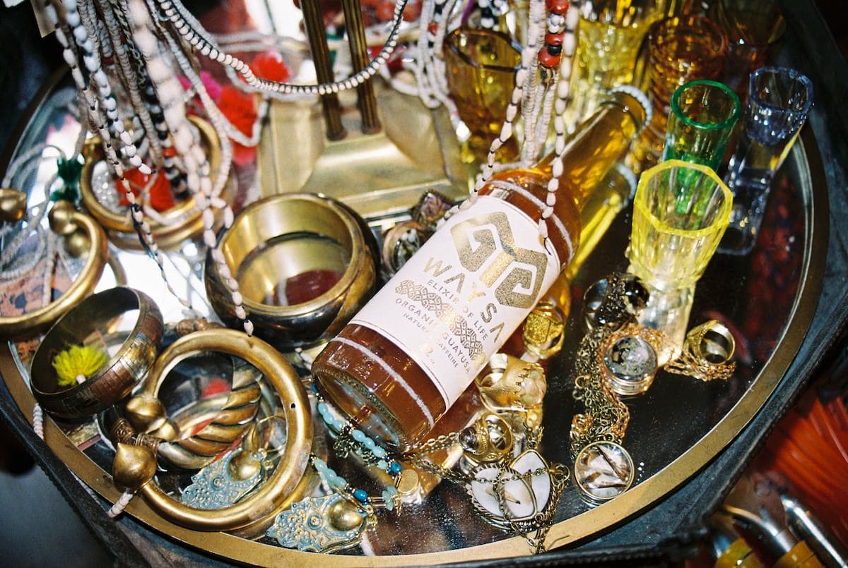 WAYSA bottle surrounded by talismans and jewellery